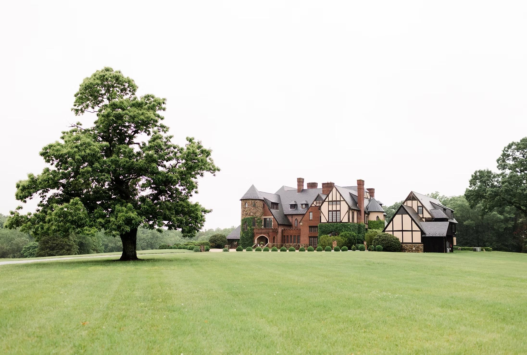 Tudor style manor house with trees and lawn